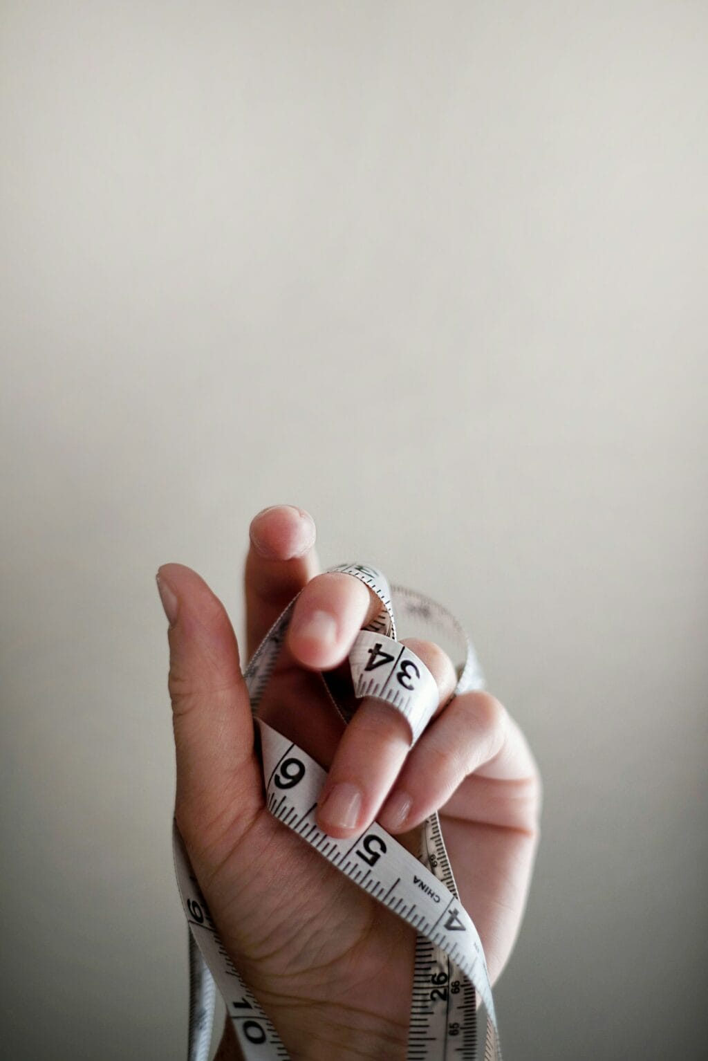 hand with measuring tape